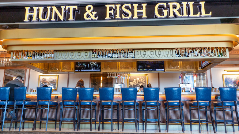 line of blue leather chairs at one of LGA's upscale airport eateries