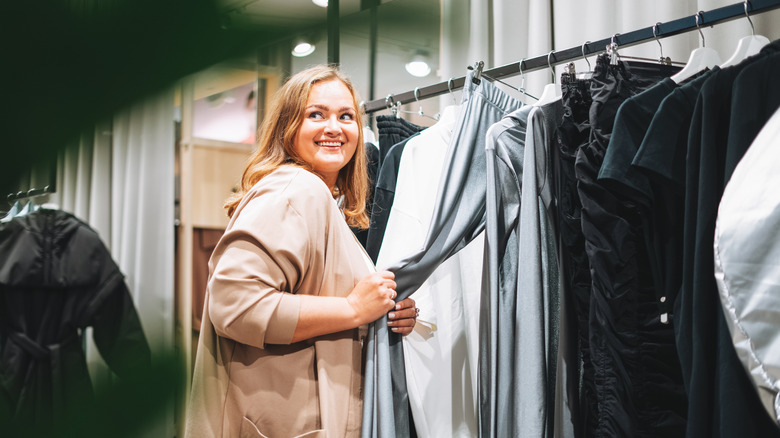 A young woman shops in a boutique shop