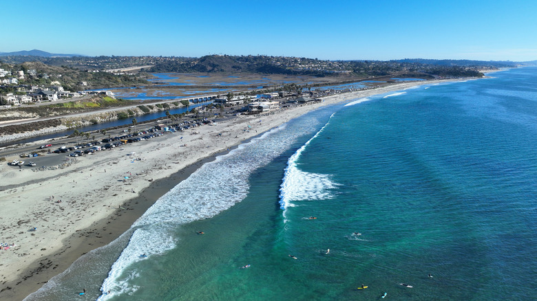 An aerial drone shot shows off the wide stretch of sand and clean waves of Cardiff State Beach