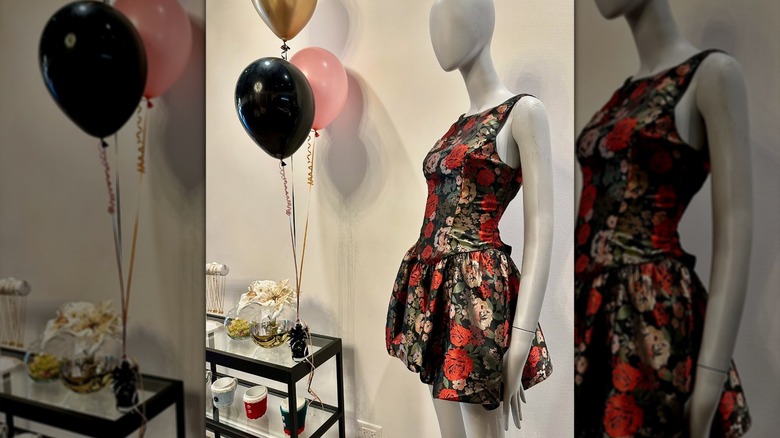 Mannequin in red and gold dress and balloons