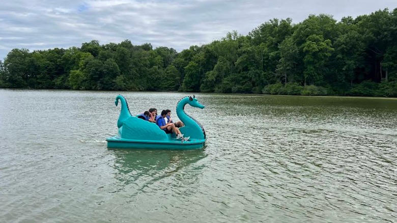 People on a dragon-shaped paddle boat in Miami Whitewater Forest