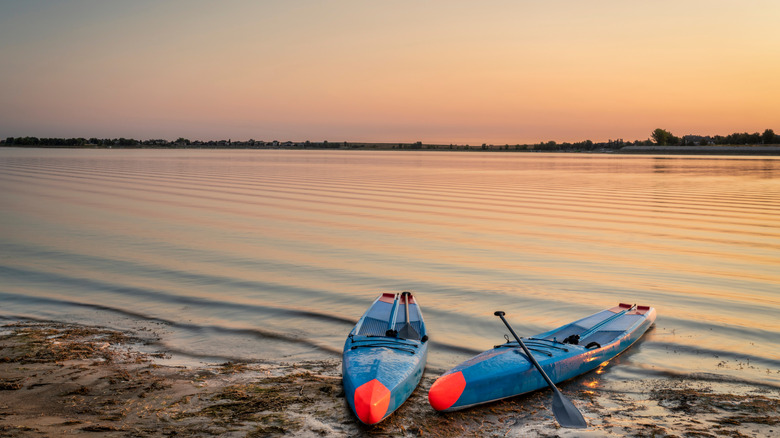 Two standup paddleboards by the glossy Boyd Lake at the namesake state park in Colorado