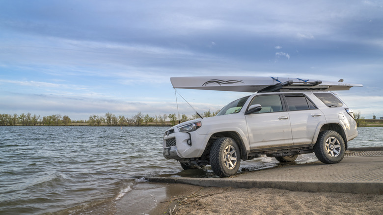A car by the shores of Boyd Lake at the namesake state park, Colorad