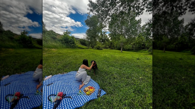 Woman picnicking with her dog at Bear Creek Lake Park, Lakewood, Colorado