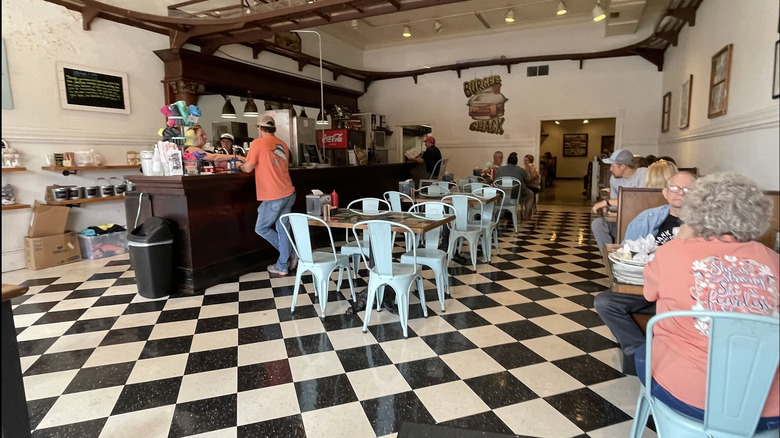 Black and white checkered floor inside Burger Shack