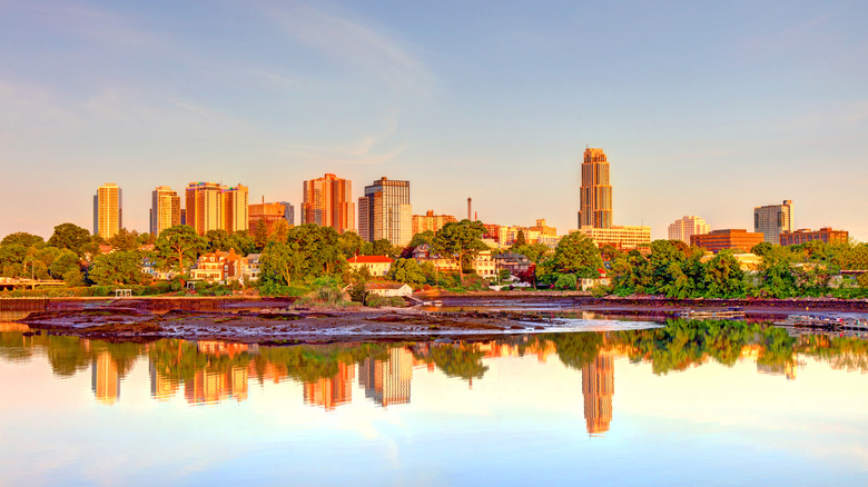 The New Rochelle skyline during golden hour, reflecting in the water with clear skies