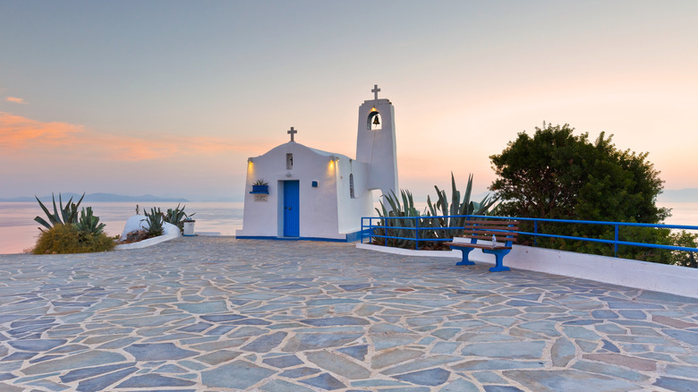 Blue and white Greek church at sunset