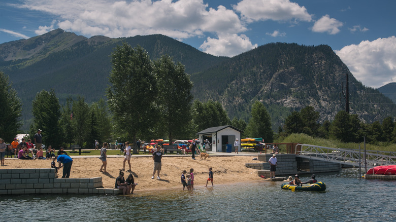 A busy day at Frisco Bay Marina with people on the beach and in the water