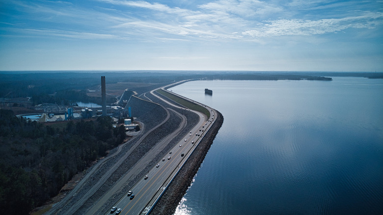 Roadway next to Lake Murray and industrial buildings in South Carolina during the day.