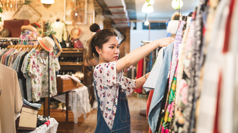 Young woman browsing shopping racks