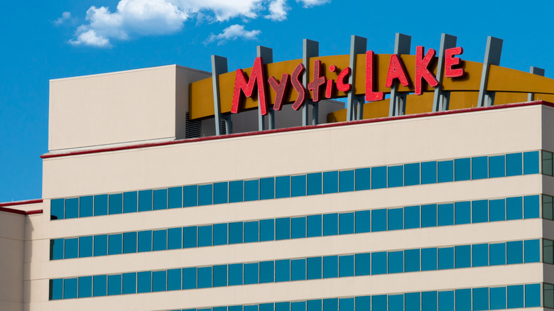 Exterior of Mystic Lake Casino against a blue sky with white clouds.