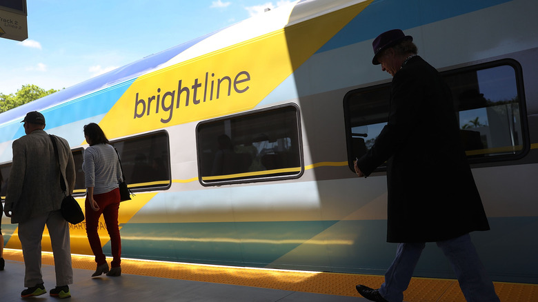 Passengers near a train at Fort Lauderdale's Brightline station