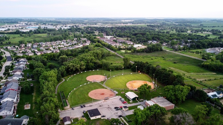 Aerial photo of Windsor Fireman's Park with baseball diamonds and rows of suburban houses lined with trees
