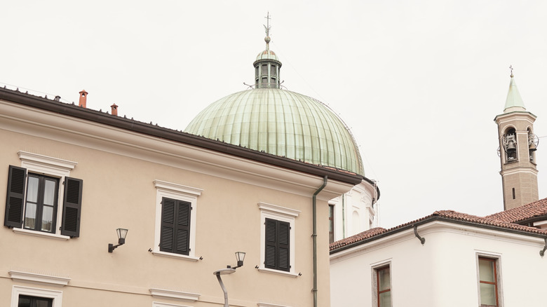The dome of the Church of St. Joseph hidden behind buildings in Seregno, Italy