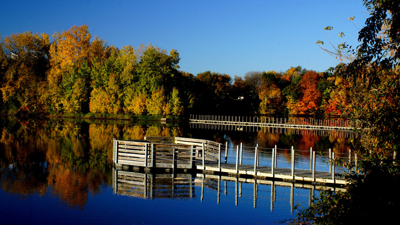 The colorful trees reflect on Prior Lake during the fall time