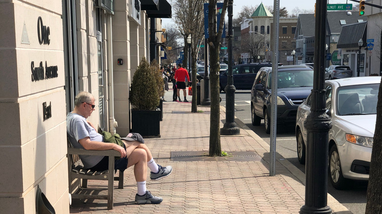 Man sitting on bench in Cranford, New Jersey's downtown