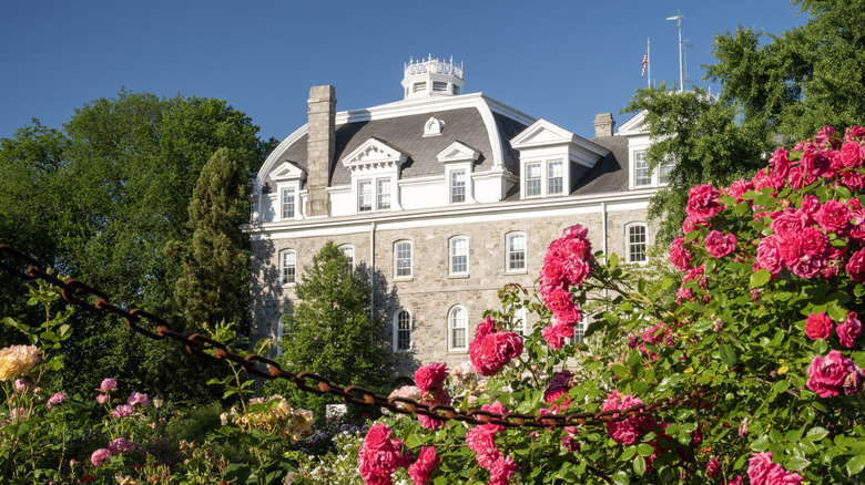 A campus building in Swarthmore College with flowers surrounding i