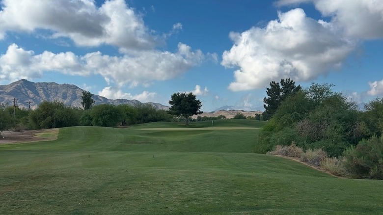 Golf course with mountains in background