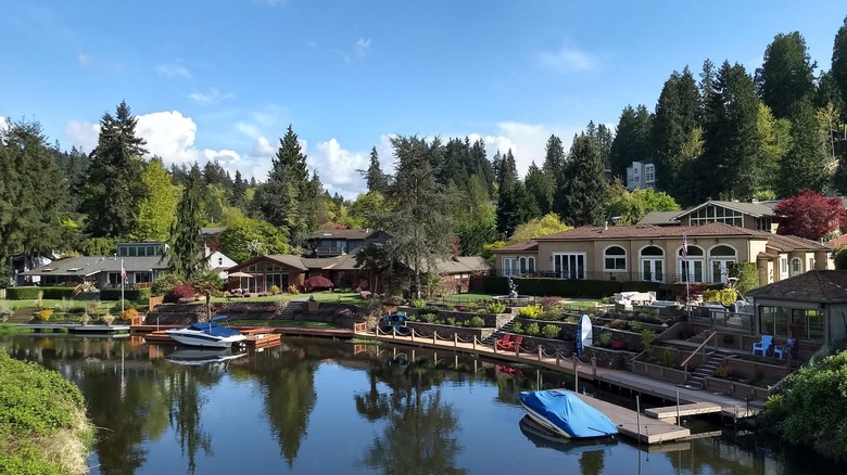 Luxury homes on riverbank with small boat landings