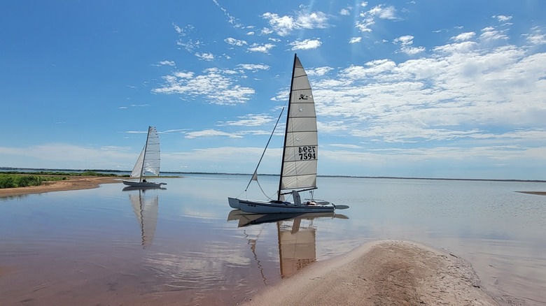 Two sailboats by the Cheney Reservoir shore at Cheney State Park, Kansas