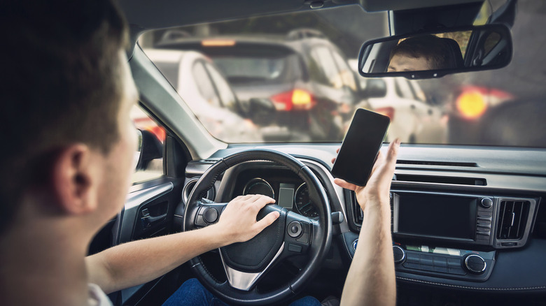 Driver in traffic honking and using phone