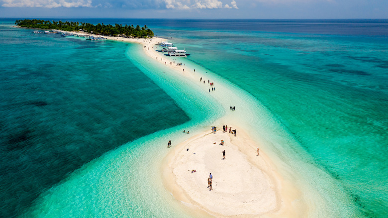 Aerial view of beachgoers scattered along sands of Kalanggaman Island in Philippines