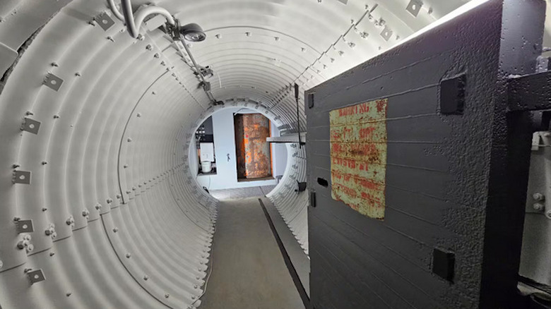 A open door leading to a shaft in the underground bunker at Atlas Ad Astra Adventure Resort