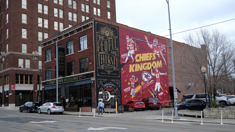 Facade of Tom's Town Distilling Co with murals on the side