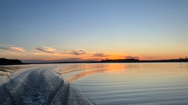 Sunset on Milford Lake with boat wake rippling in water