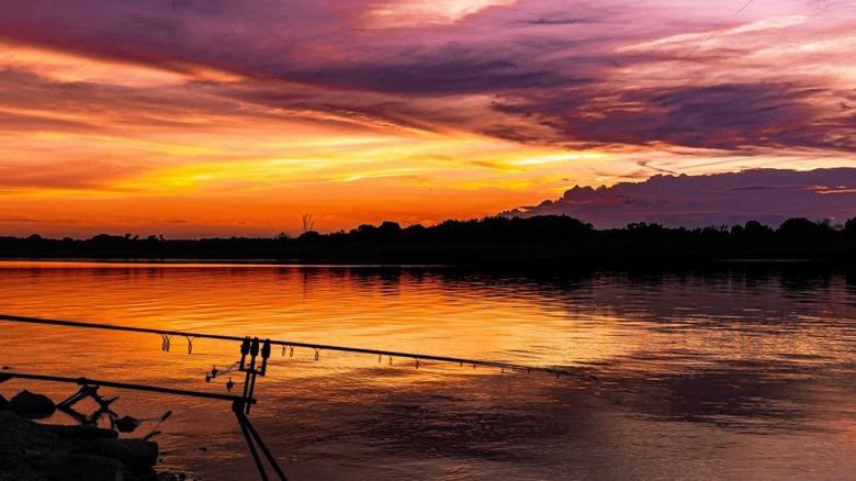 Incredible sunset with orange, yellow, purple sky reflecting on Milford Lake, Kansas