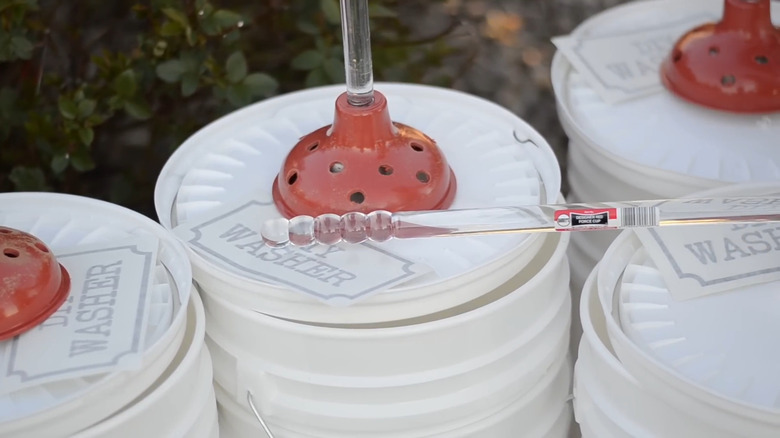 One version of a DIY camping washing machine, with buckets and plungers
