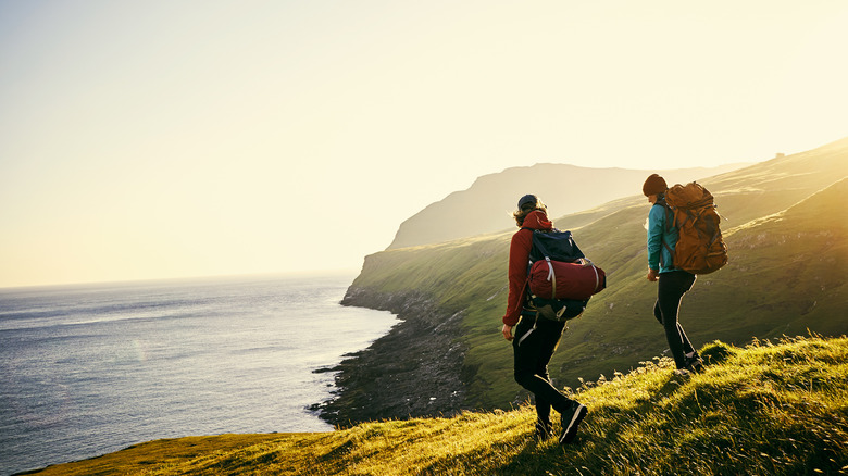 two backpackers on coast