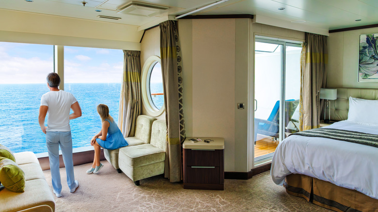 A couple enjoys their stateroom on a cruise ship