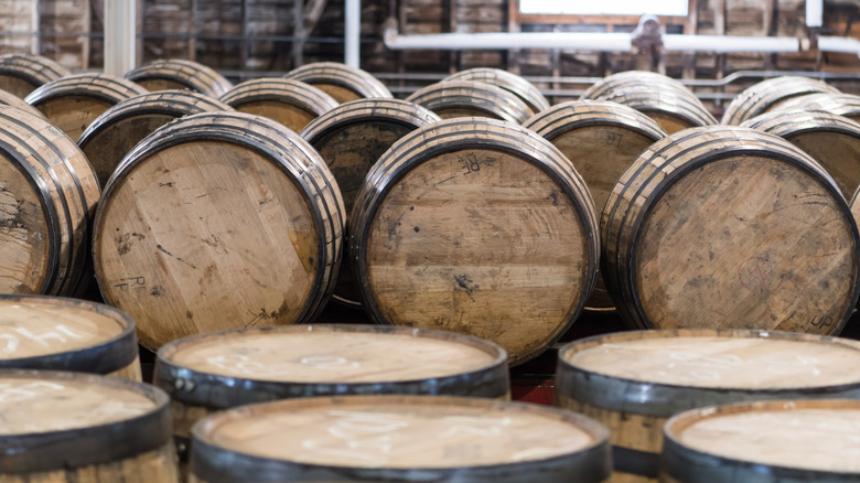 Rows of stacked whiskey barrels inside a whiskey house on the Kentucky Bourbon Trail.