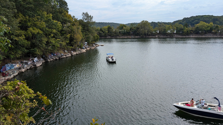 Two boats on Kentucky Lake, with trees on the shore and a blue sky above