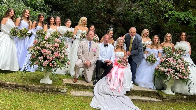 Queen candidates in white dresses with pink flowers in Laurel Cove during the Kentucky Mountain Laurel Festival
