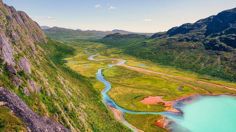 valley with glacial lake and summer mountain scenery near Jotunheimen Norway