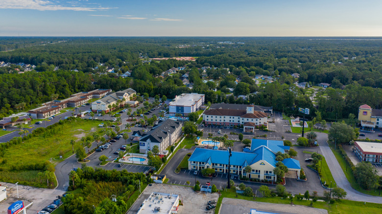 Aerial views of Kingsland, Georgia, featuring hotels and homes surounded by dense woodlands.