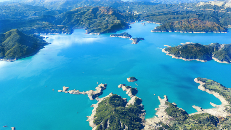 An aerial view of Lake Kremasta, ringed by rocky and verdant land in the Agrafa Mountains in Central Greece