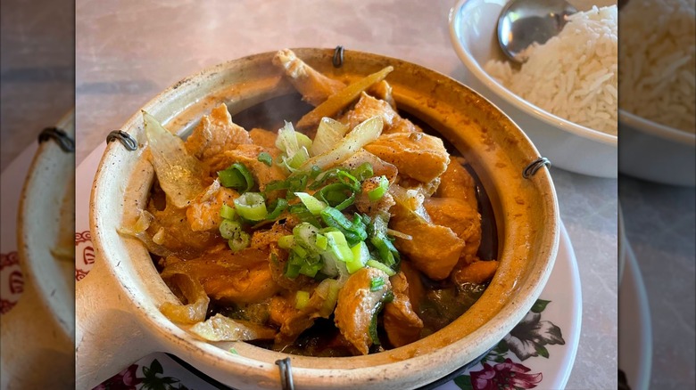A stir-fry meal in a bowl with a side of rice at Vietnamese Restaurant in La Vista, Nebraska