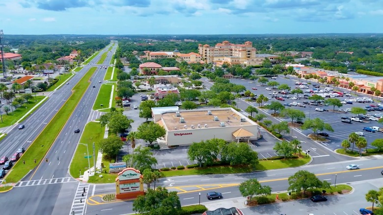 Verdant streets of Lady Lake with stores, parking lots, and buildings, Florida