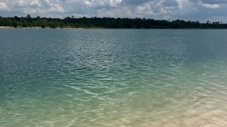 Clear blue water and white sands at Lake Isabel Farm in Louisiana