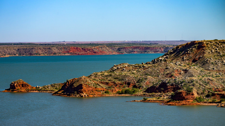 the bright blue-green water of Lake Meredith contrasted with the red-brown cliffs surrounding it.
