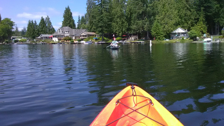Kayaks on Lake Roesiger with houses and trees