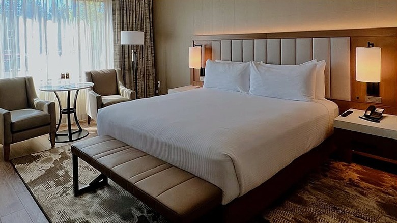 A well-presented Golden Nugget hotel room with king-size bed and seating.