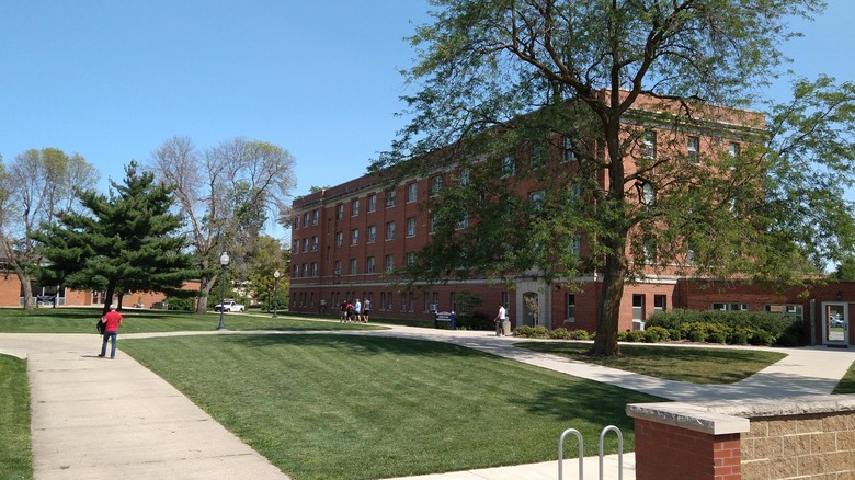 A brick building on the campus of Graceland University surrounded by walkways and a green lawn