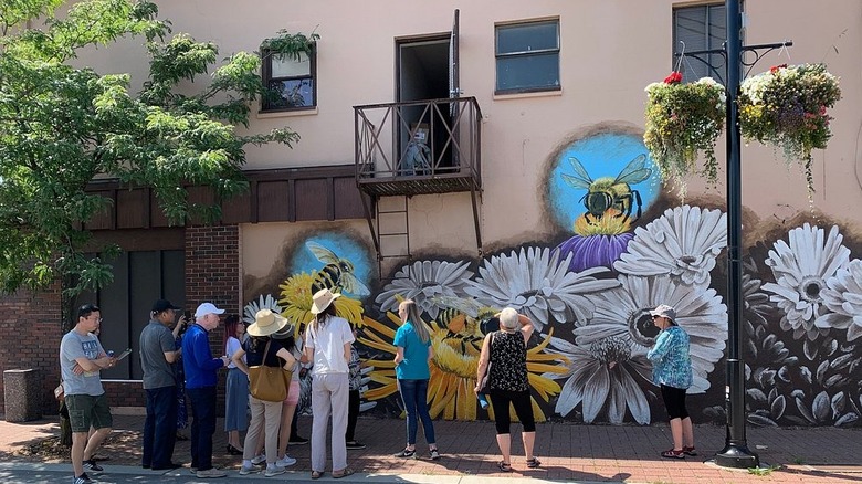 People walking along the Downtown Langley Mural Walk in the city of Langley, British Columbia, Canada