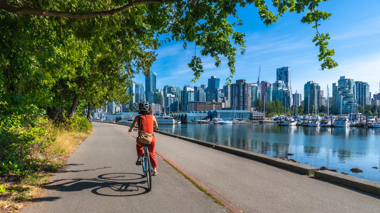 A bike-rider cruising along the water in Vancouver, British Columbia, Canada