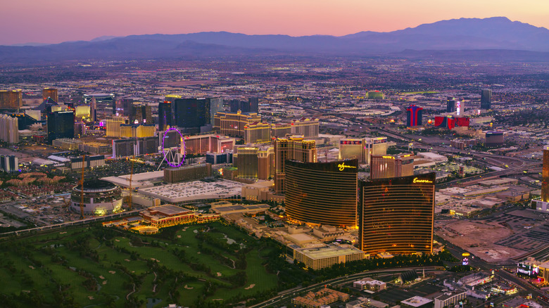 Aerial view of Las Vegas strip at sunset with Wynn Encore visible.