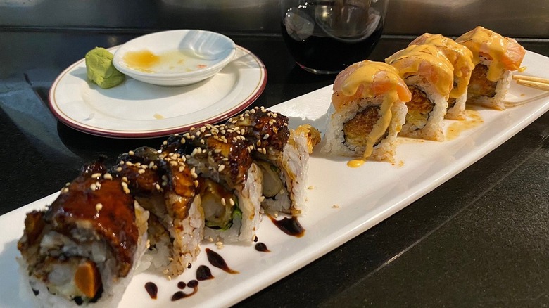 A plate of sushi on a black counter